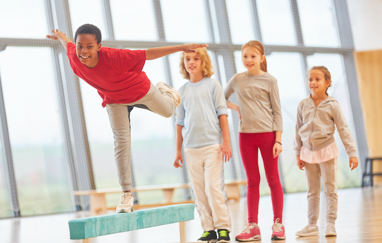 PE lesson boy hurdling in athletics