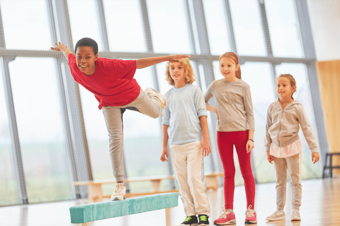 Boy performing a one point balance in gymnastics