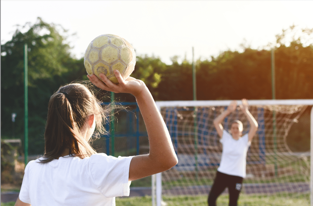 Girls playing handball in primary school PE