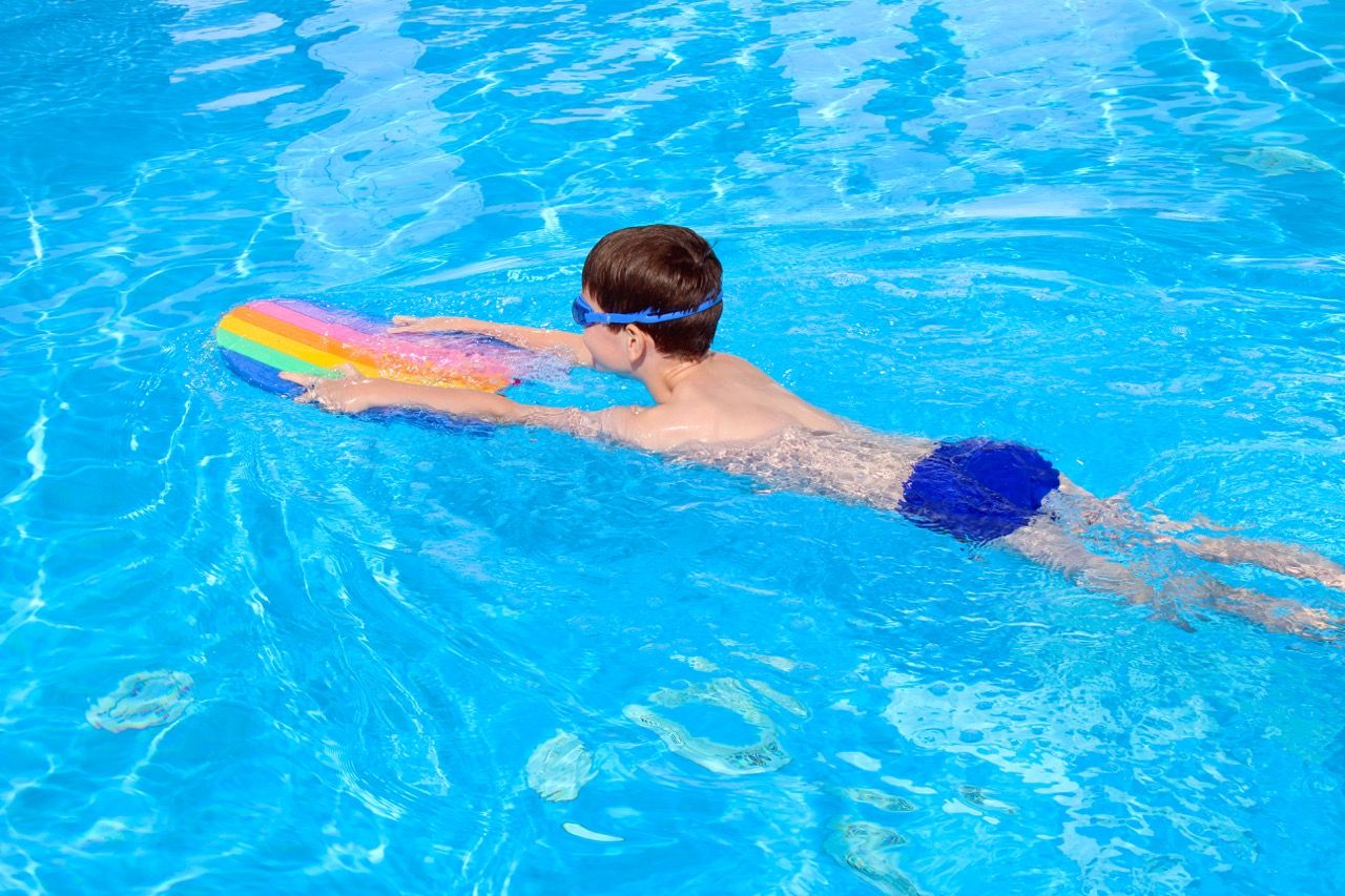 Picture of boy swimming in an outdoor swimming pool