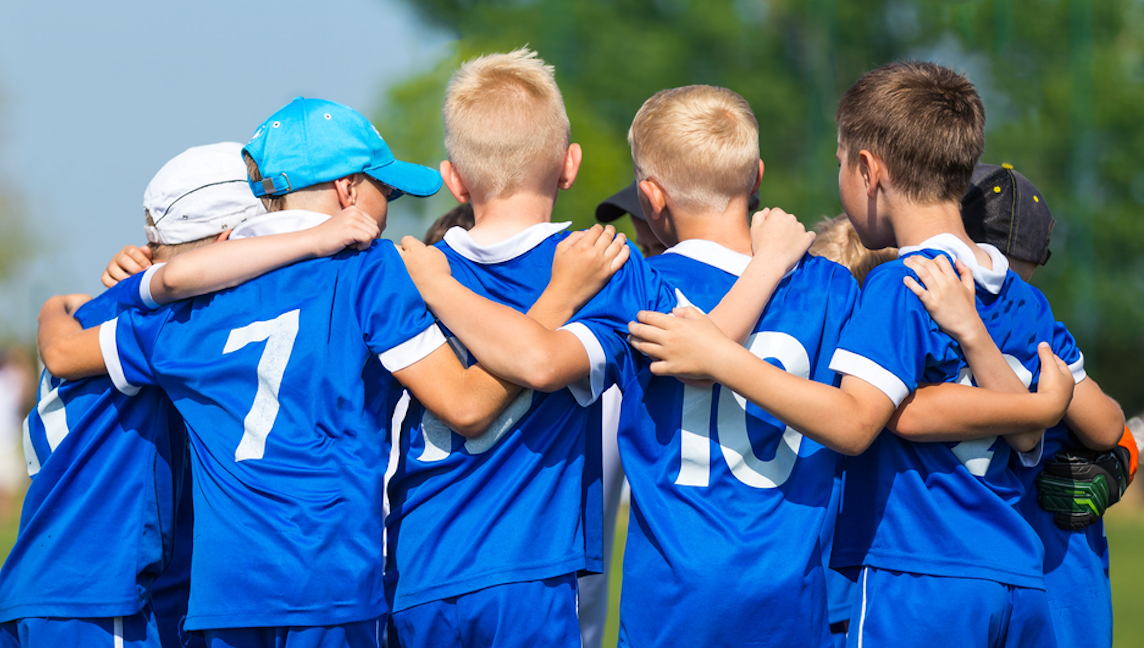 Children in a team huddle 