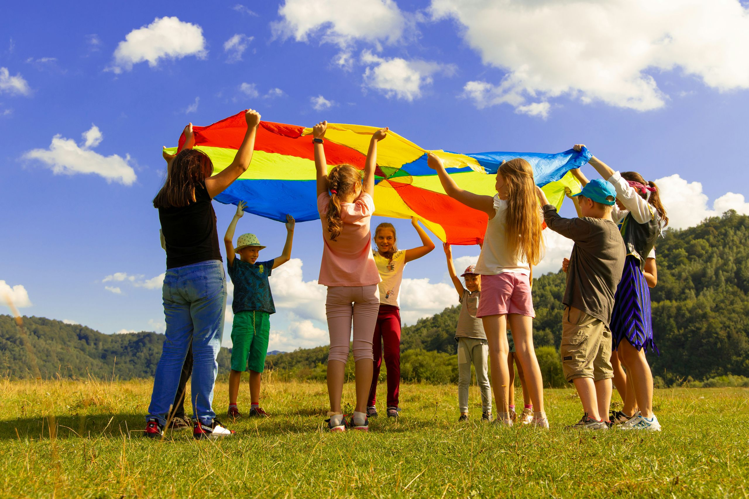 Children playing with a parachute with lots of colours