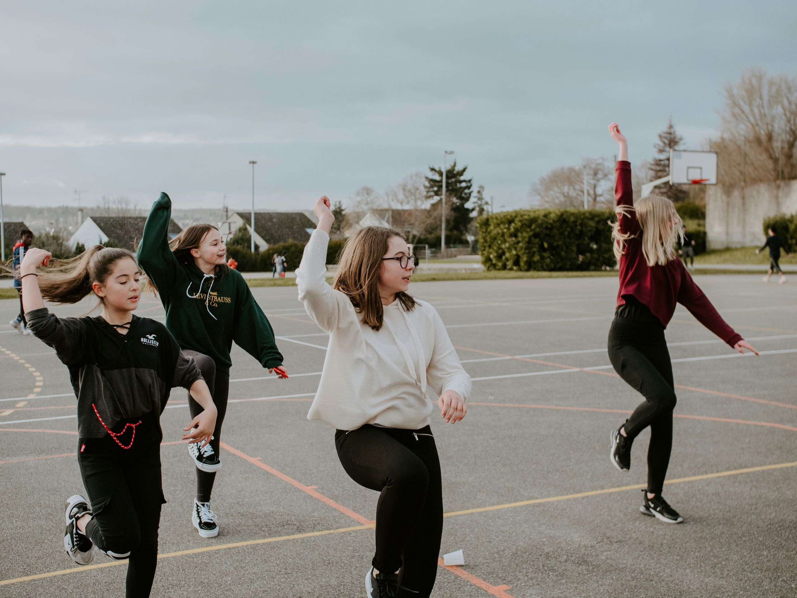 Children making shapes in the playground