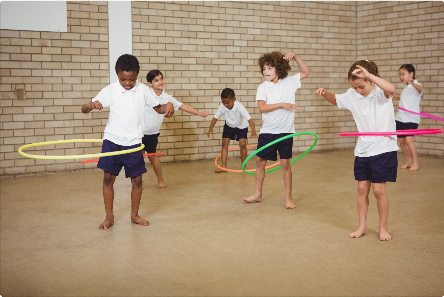 children with hoops in pe lesson