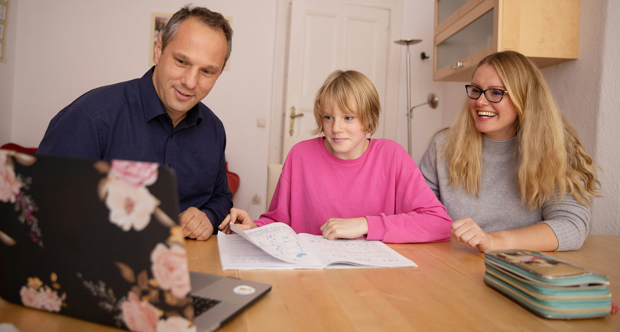 A student studying with parents