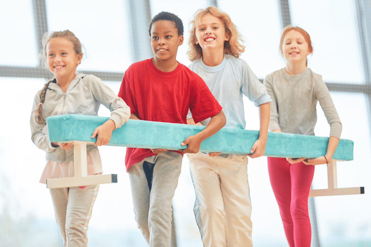 Children carrying gym apparatus