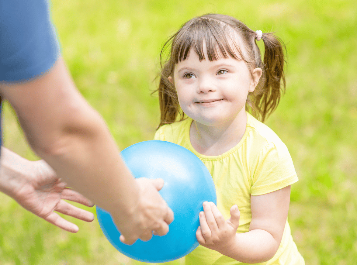 Girl with ball and teacher